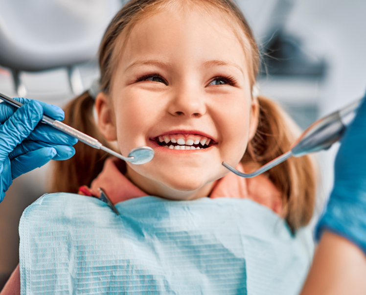 Little girl smiling in dentist chair