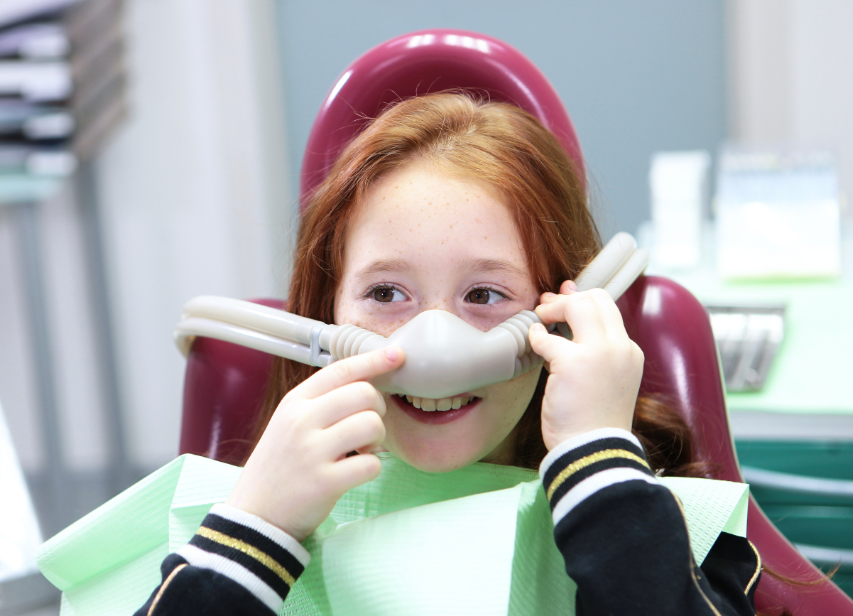 Little girl with dental sedation mask